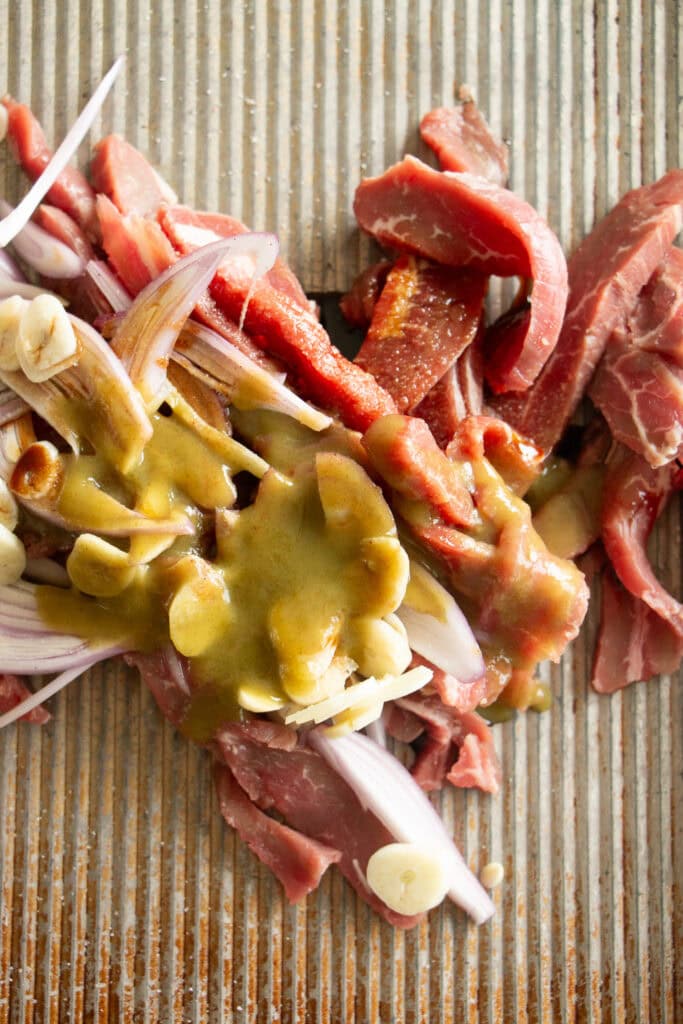 sheet pan with beef, shallot, garlic, and hot sauce