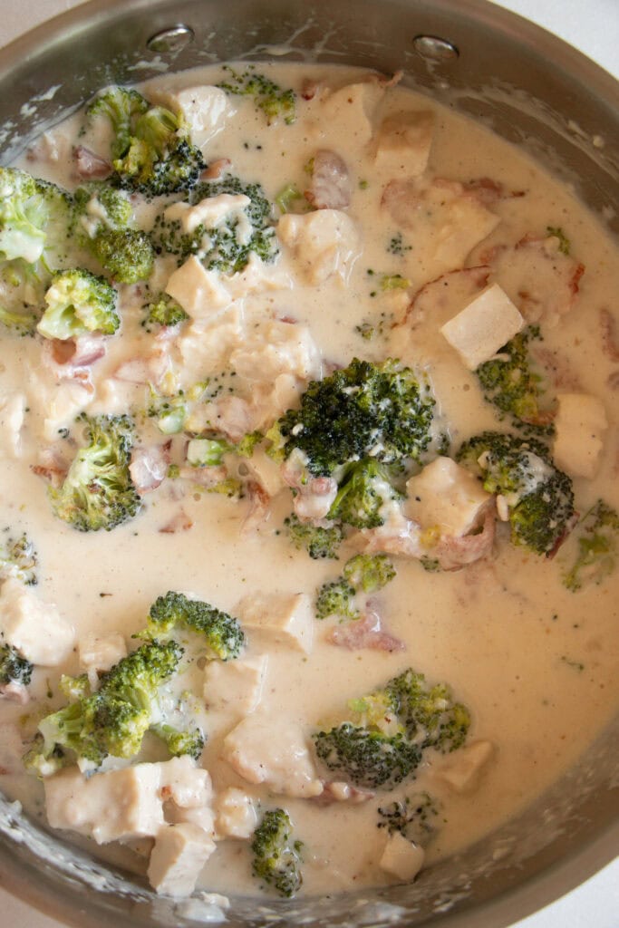chicken, broccoli, and bacon in a pan with homemade alfredo sauce