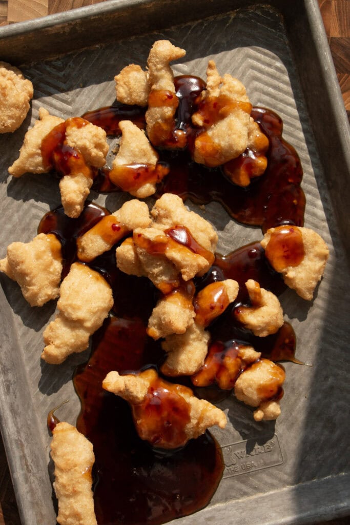 crispy chicken with sauce on a sheet pan 