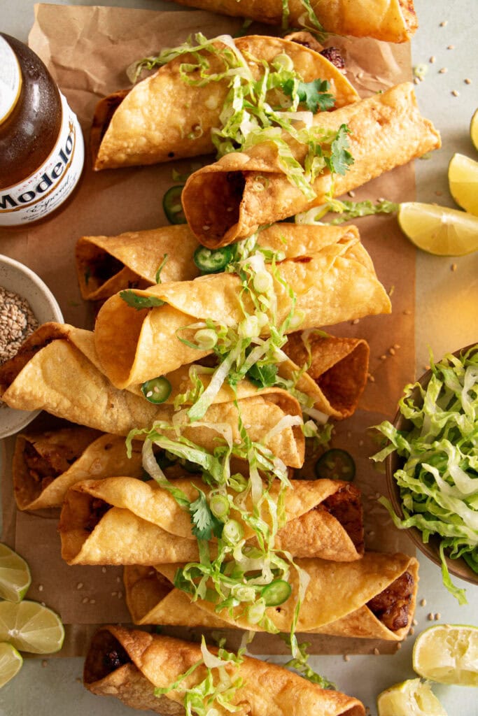 honey chicken taquitos topped with shredded lettuce