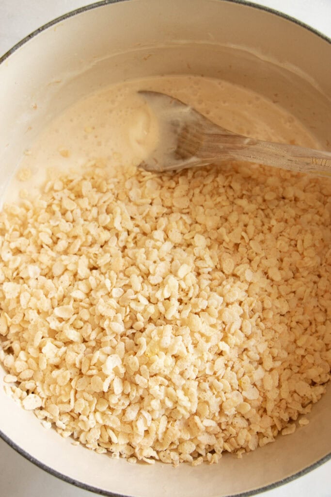 melted marshmallows in a Dutch oven with rice cereal 