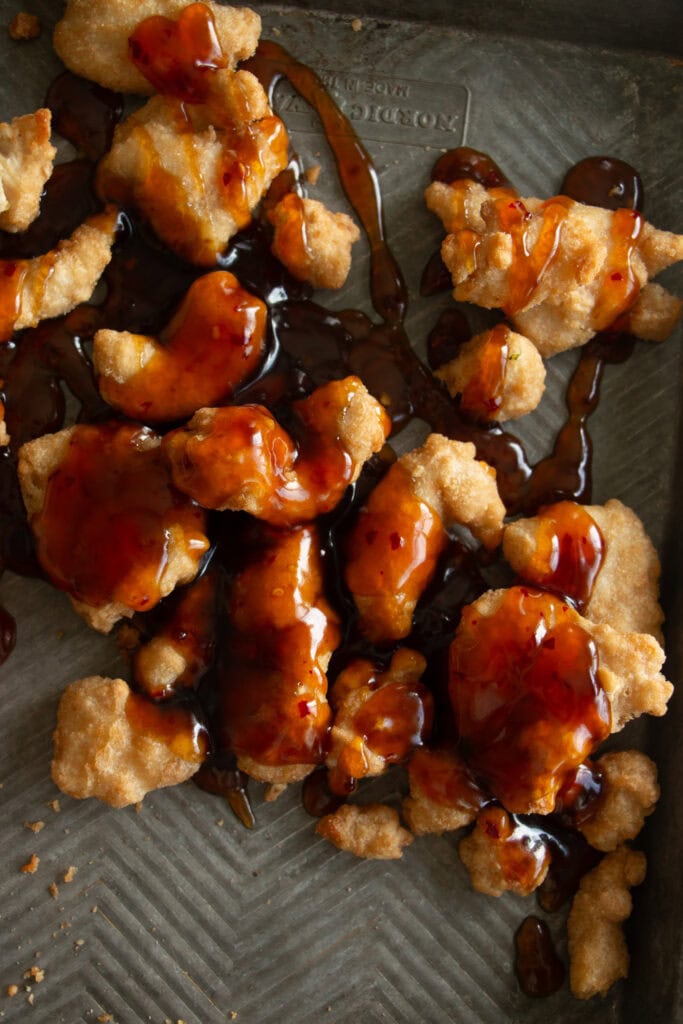 crispy chicken with sauce on a sheet pan