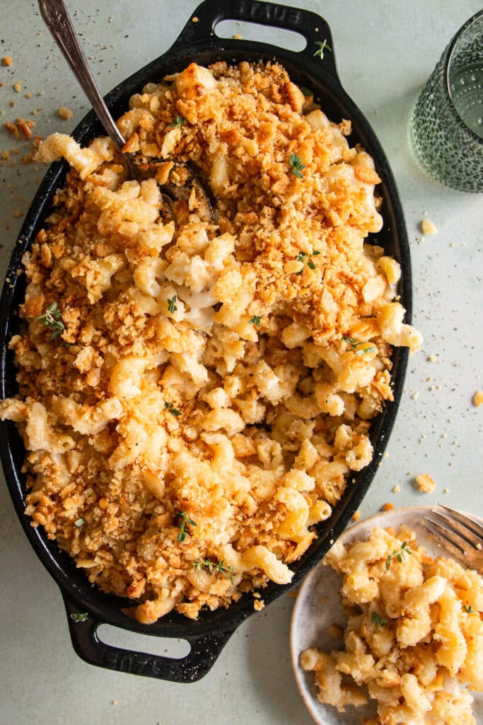 Large oval baking dish loaded with baked mac and cheese