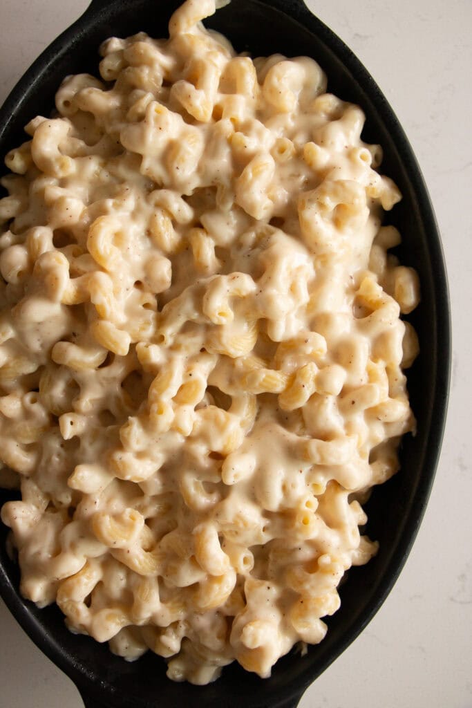 Greased baking dish with mac and cheese mixture