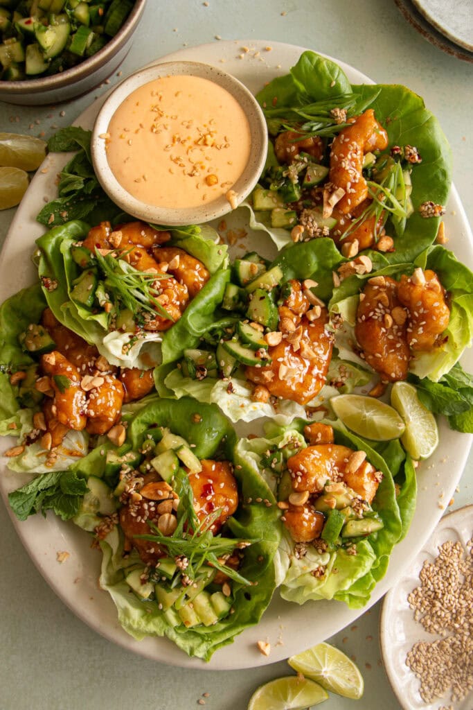 large platter with crispy chicken lettuce cups and sriracha mayo