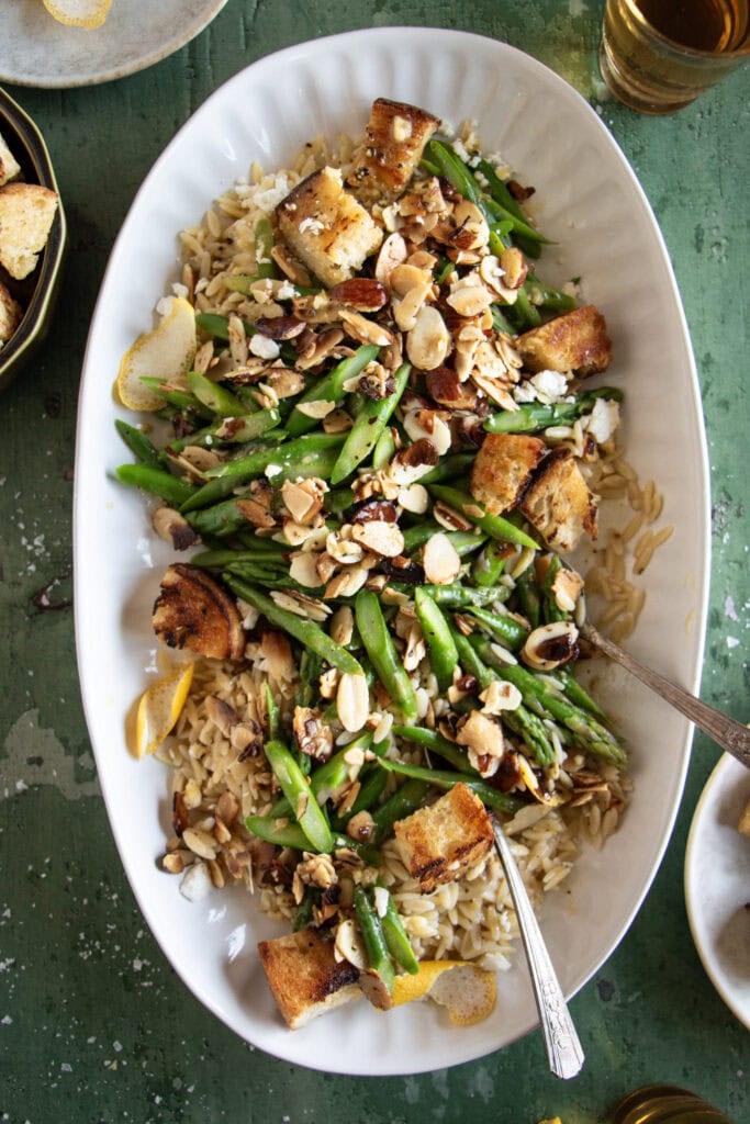 oval plate with cold asparagus and orzo salad 