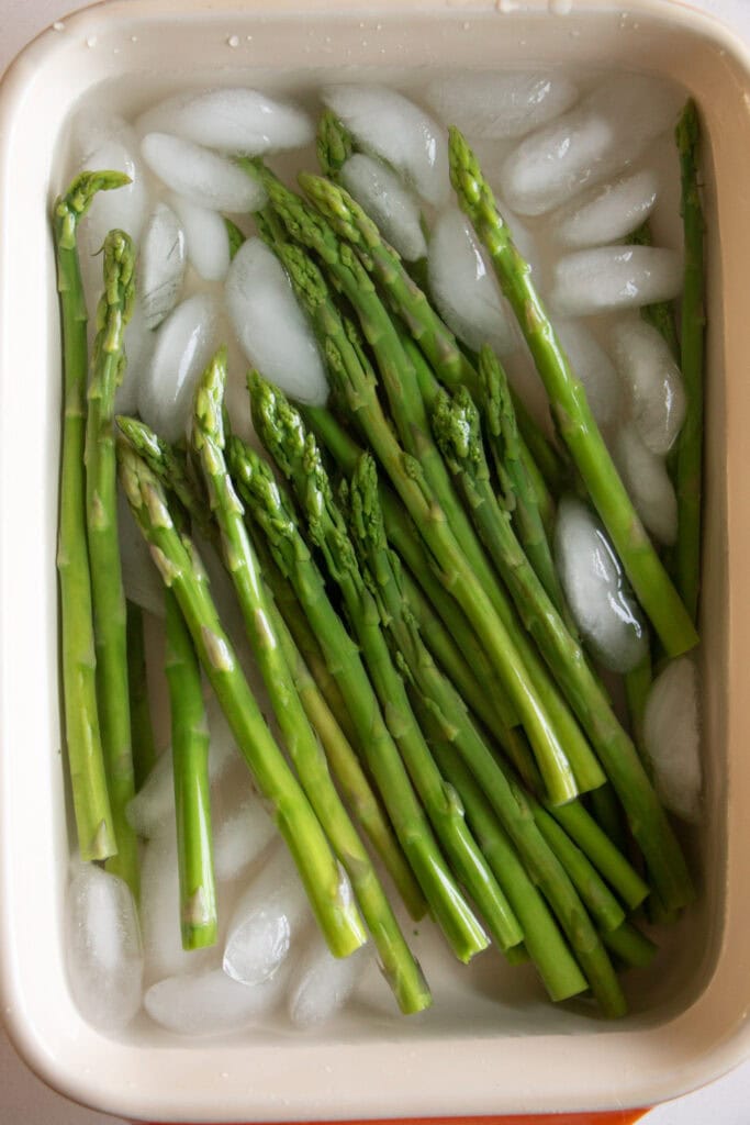 cooked asparagus in an ice bath 