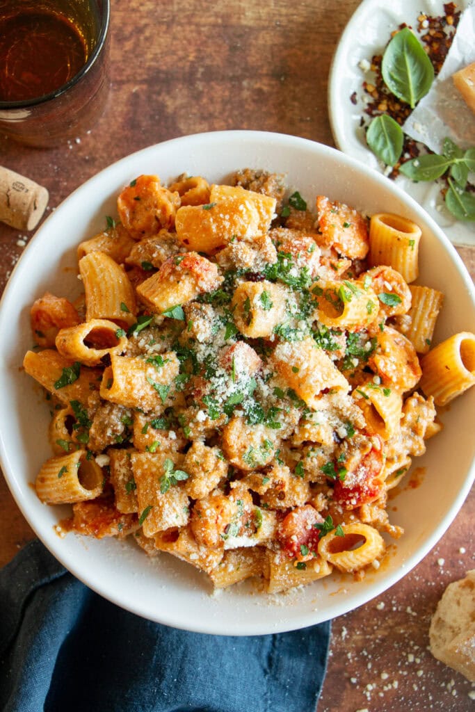 big bowl of spicy rigatoni pasta topped with Cajun cream sauce, shrimp, and Italian sausage