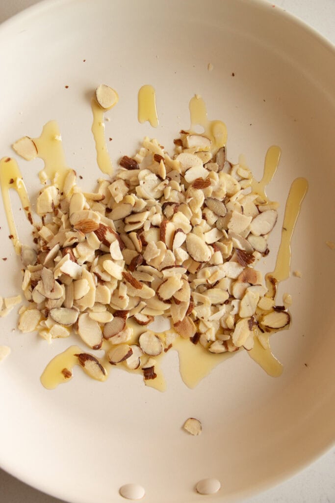 almond slices in a pan with olive oil