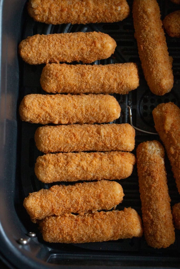 frozen cheese sticks in an air fryer basket