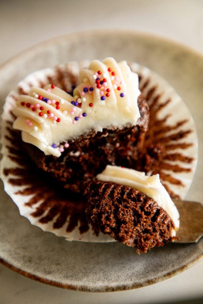 chocolate cupcake unwrapped white a bite removed