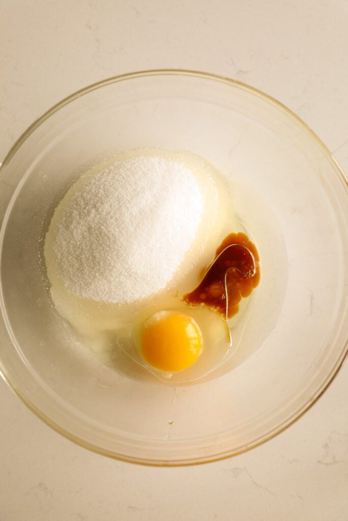 Mixing bowl with oil, sugar, vanilla, and egg.