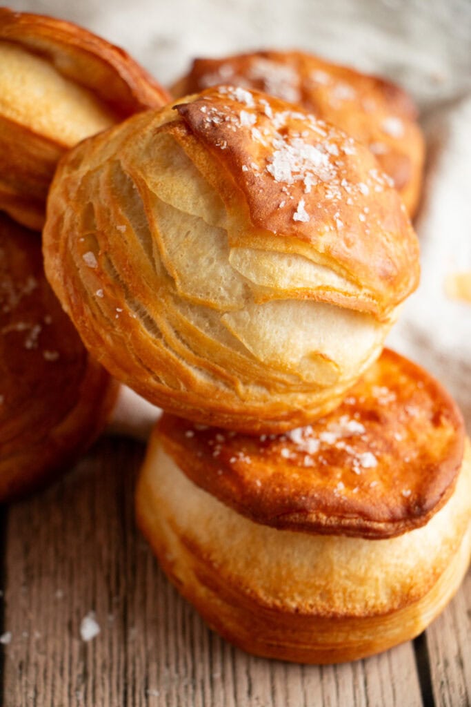 Basket full of golden brown Pillsbury biscuits with salt on top 