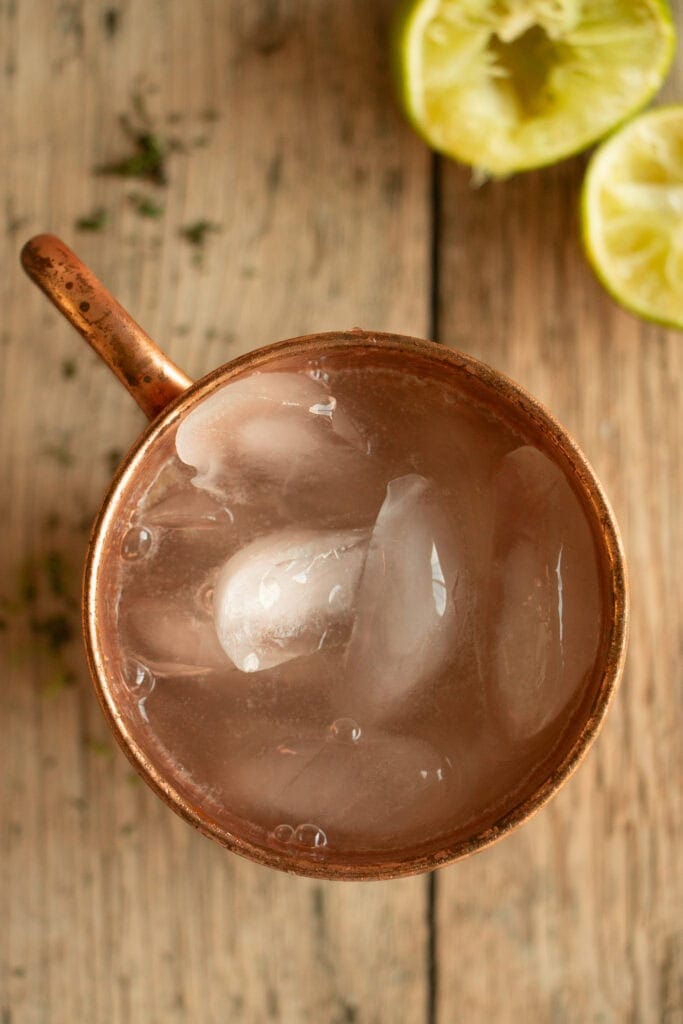 copper mug filled with ice and ginger beer