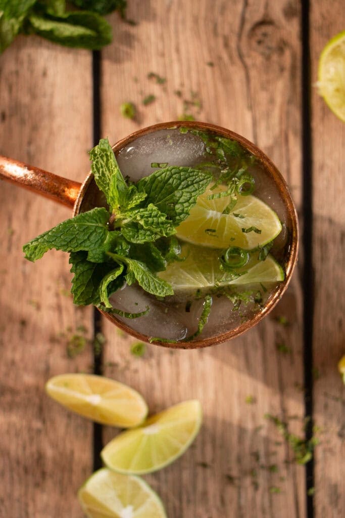 Copper mug filed with gin Moscow mule and topped with lime