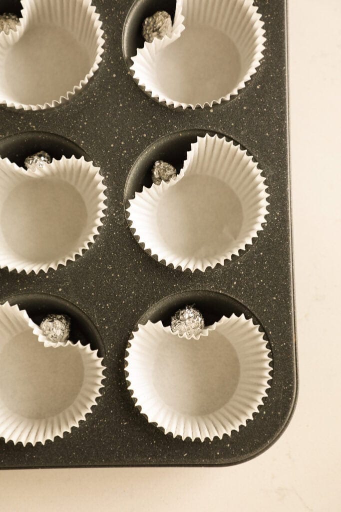 Lined muffin tin with paper liners shaped as hearts