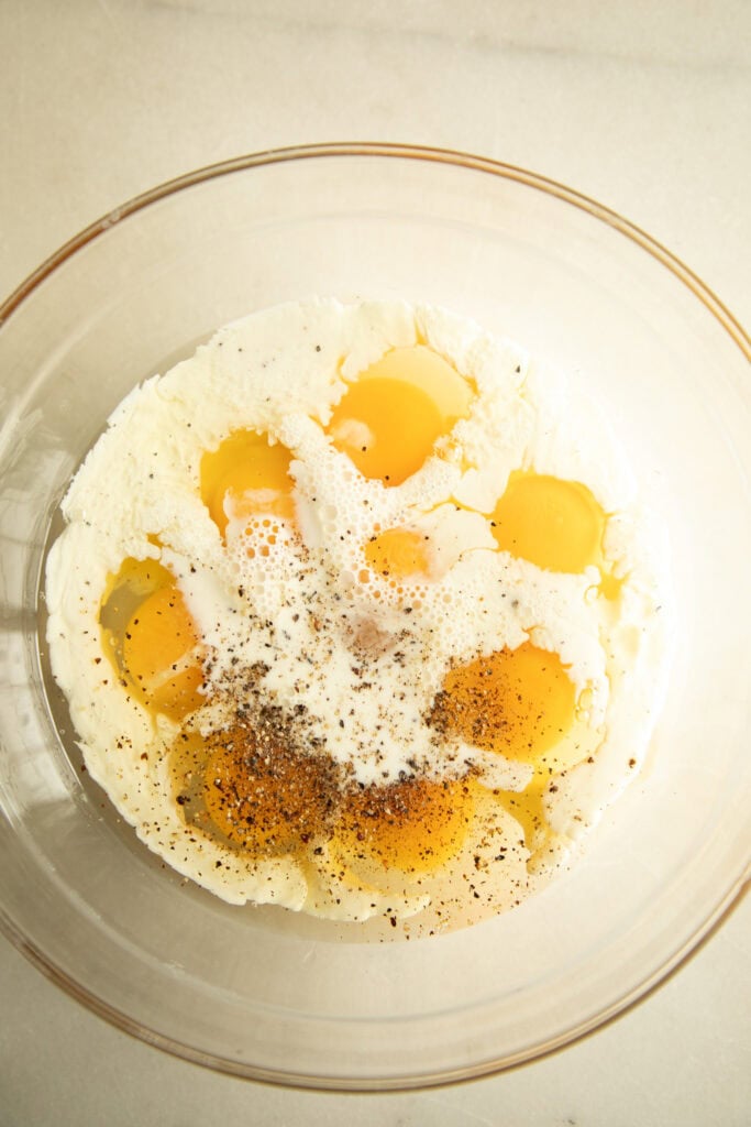 Mixing bowl with eggs, milk, and seasoning