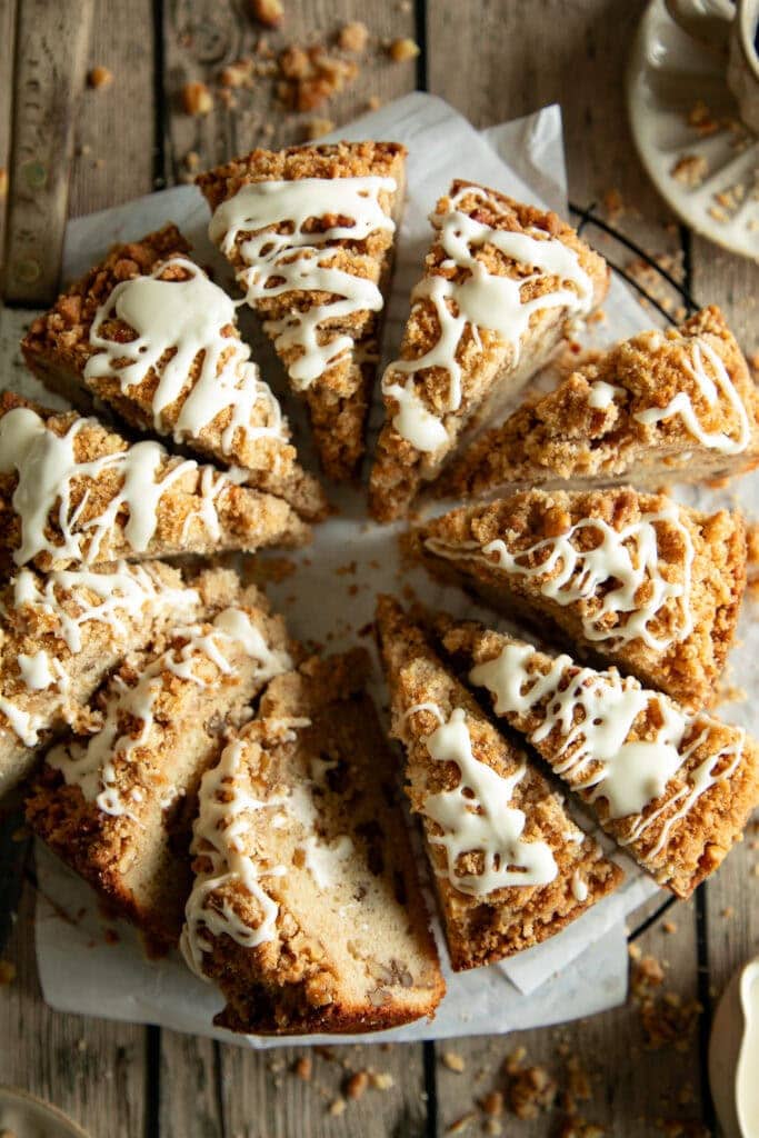 Round coffee cake, sliced on parchment paper with glaze on top