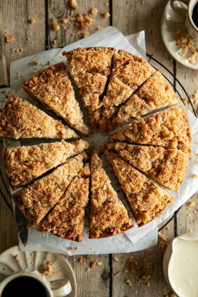 Sliced walnut coffee cake on a wire rack 
