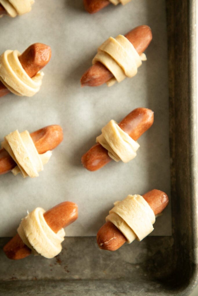 sheet pan with rolled pigs in a blanket