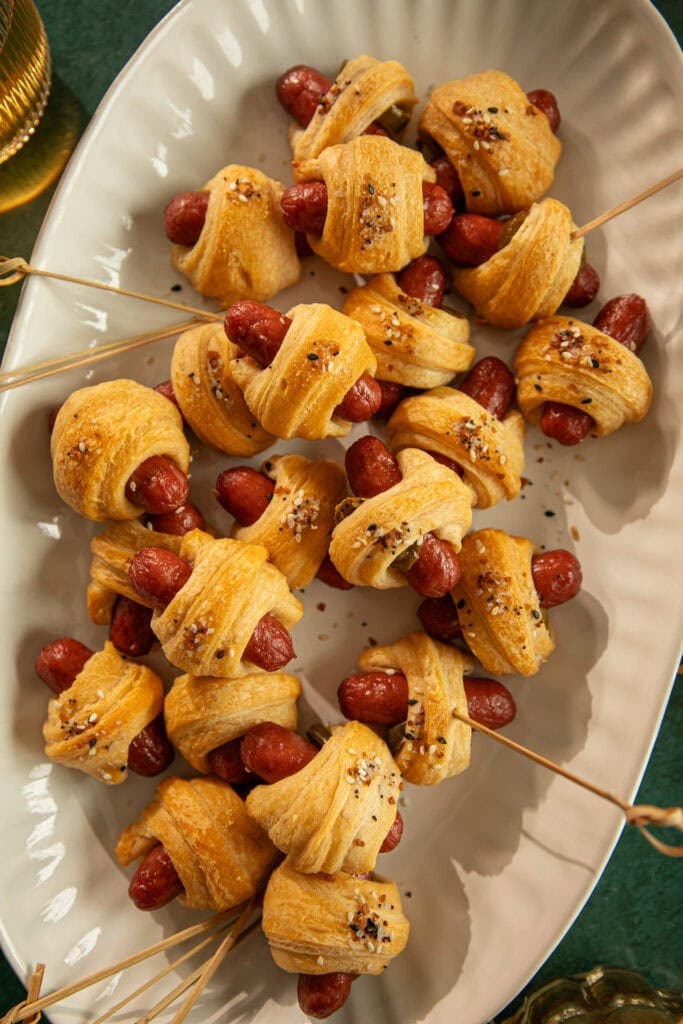 Platter with cooked little smokies and wooden skewers