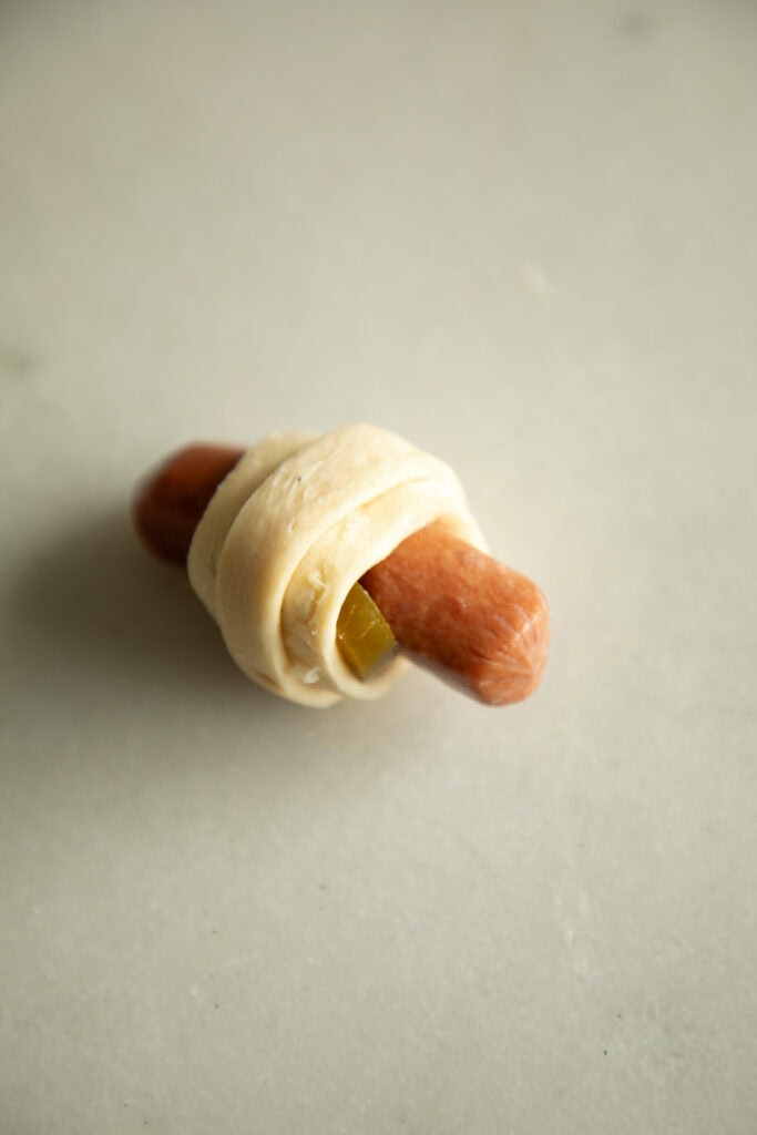 rolled up uncooked pig in a blanket