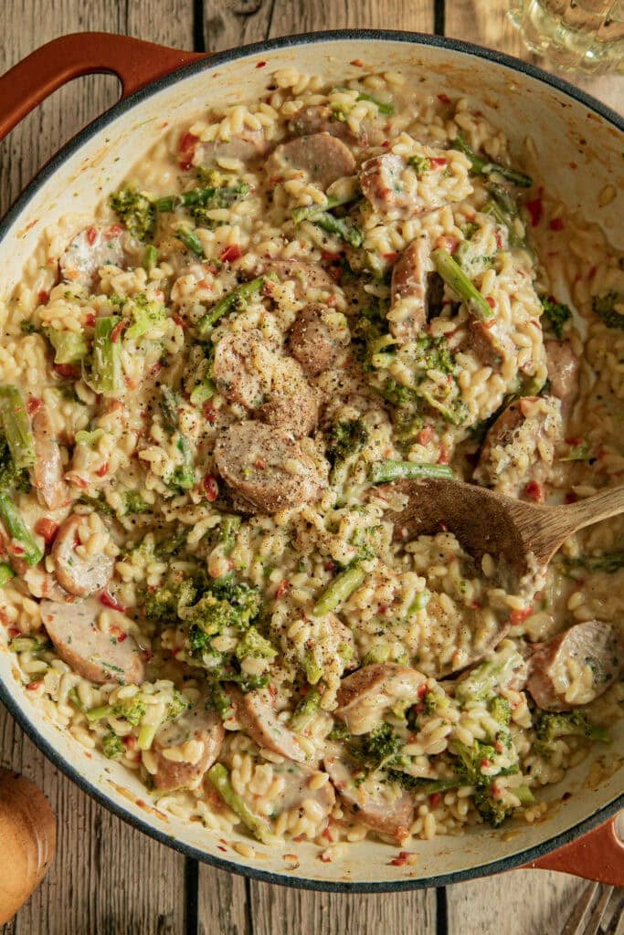 Large Dutch oven full of sausage and veggies with orzo