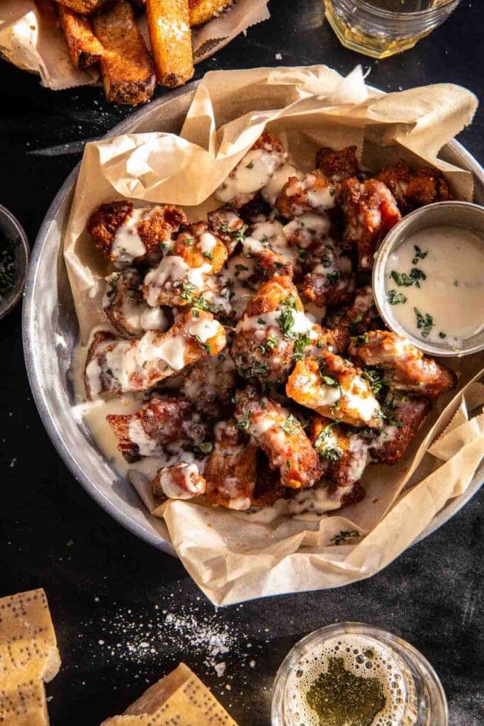 Boneless wings in a bowl with garlic parmesan sauce