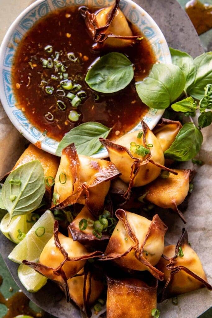 shrimp Rangoon's on a tray with sauce
