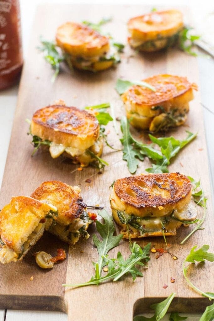 Mini grilled cheese sandwiches on a board