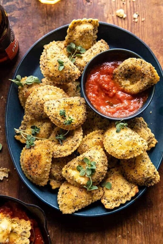 Fried raviolis on a plate with sauce