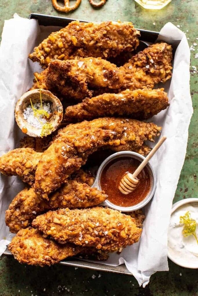 Crispy chicken tenders in a pan with parchment paper