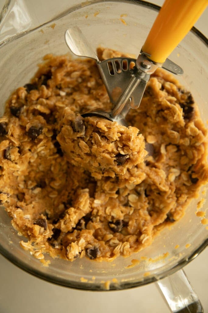 Mixing bowl with cookie dough and a portion scoop
