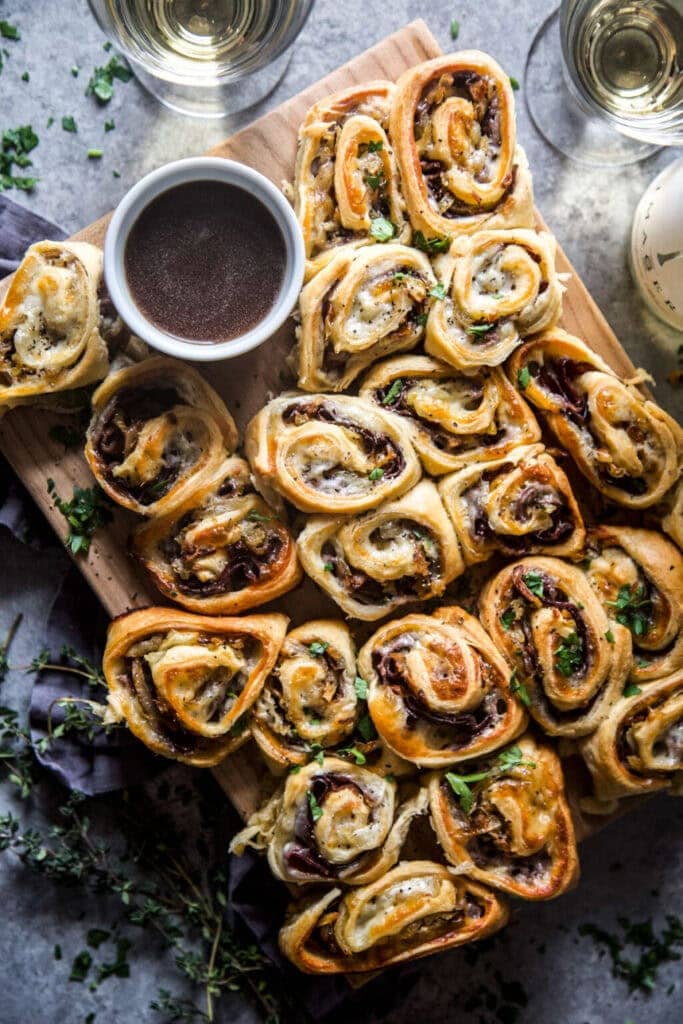 French Dip pinwheels on a board with au jus