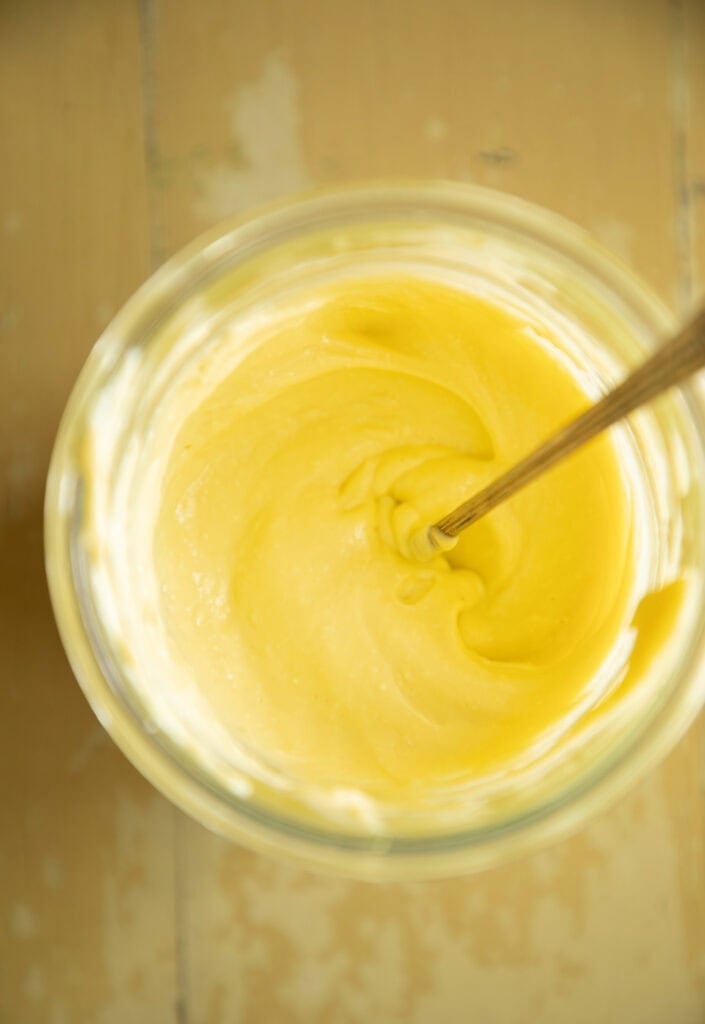 container of homemade mayo with a spoon