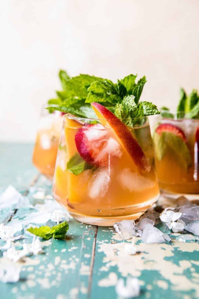 Glasses full of peach strawberry sweet tea julep