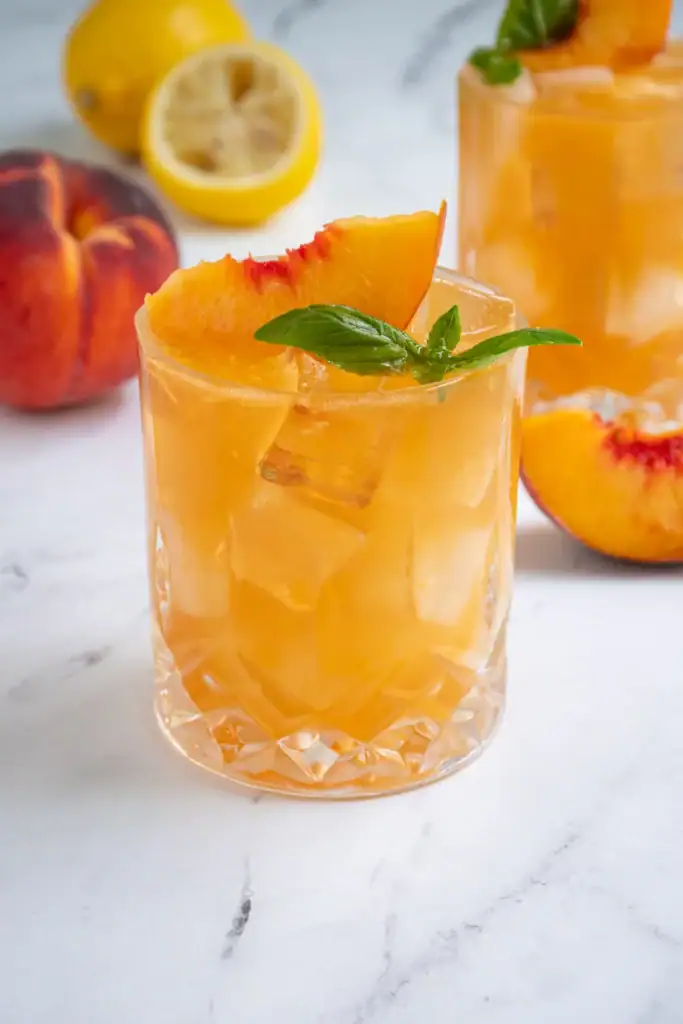 Peach bourbon smash cocktail