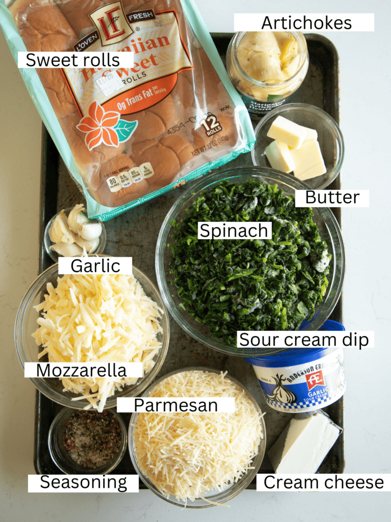 sheet pan with the prepped and portioned ingredients needed to make the spinach dip sliders