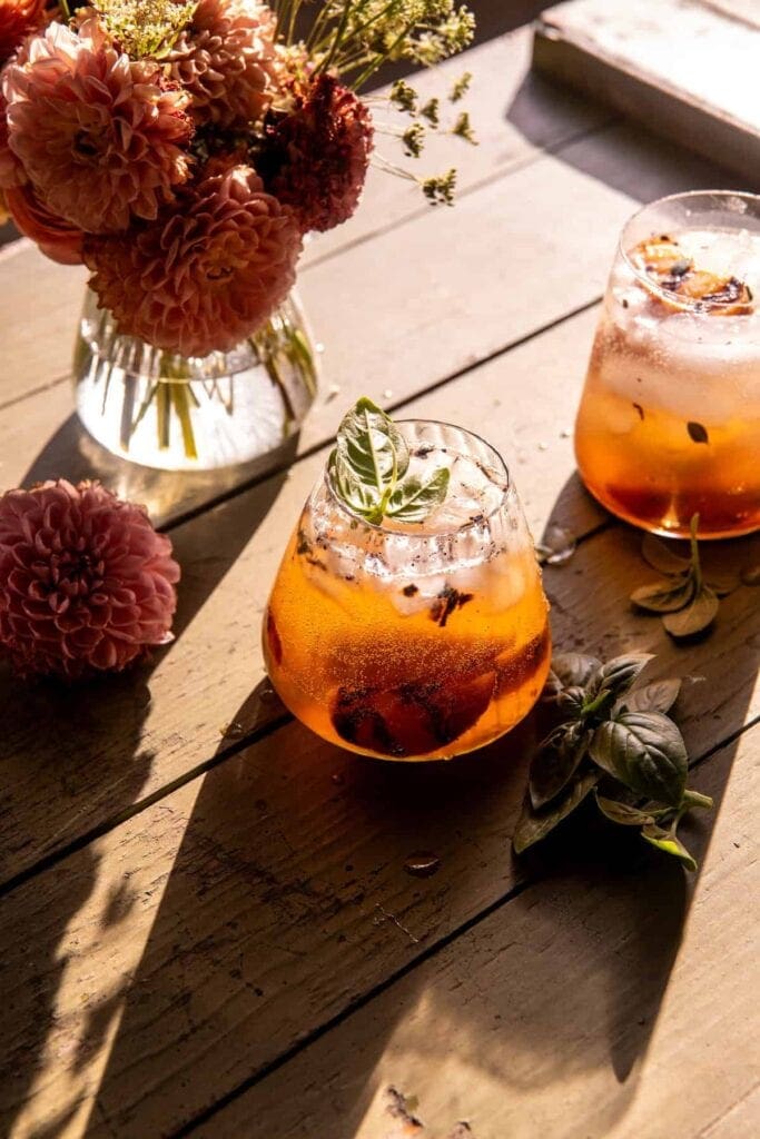 Wooden table with two glasses of peach smash