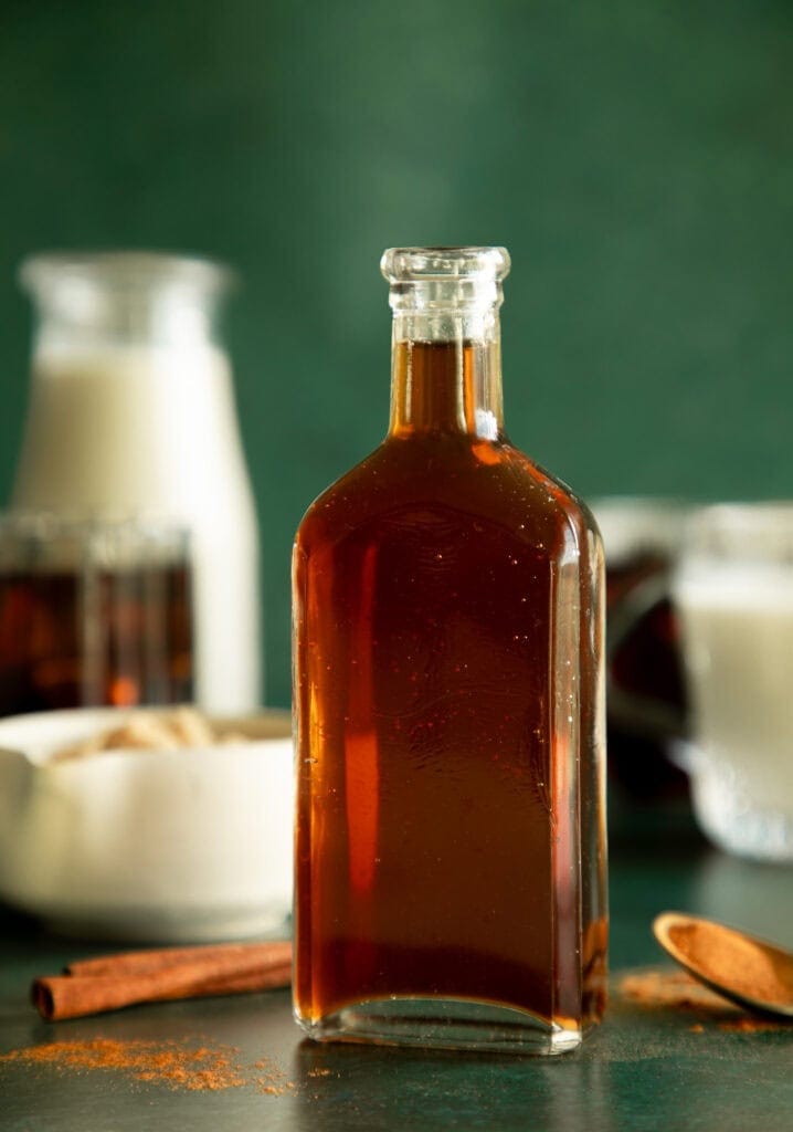 Glass bottle full of cinnamon dolce simple syrup