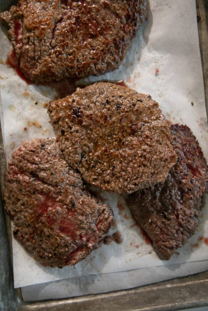 seared cube steaks on parchment paper