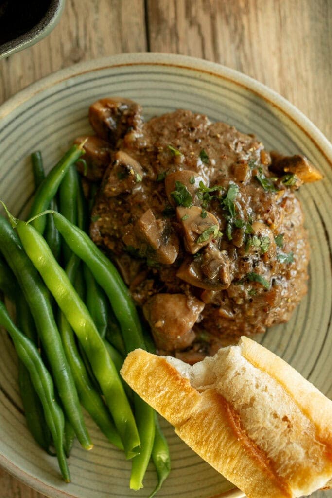 plate with green beans and cube steak with gravy 