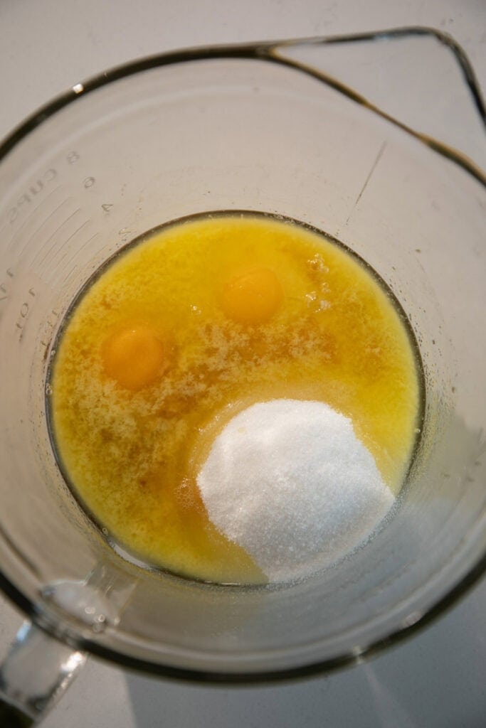 mixing bowl with eggs and melted butter