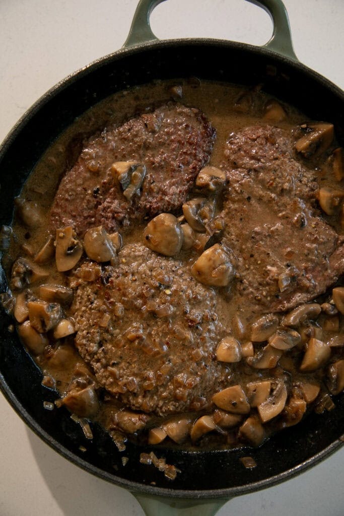 Cube steaks placed back in the pan with the gravy