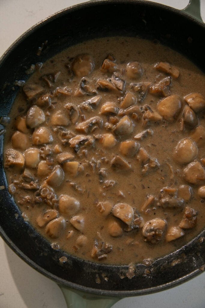 Creamy pan gravy with mushrooms in a skillet