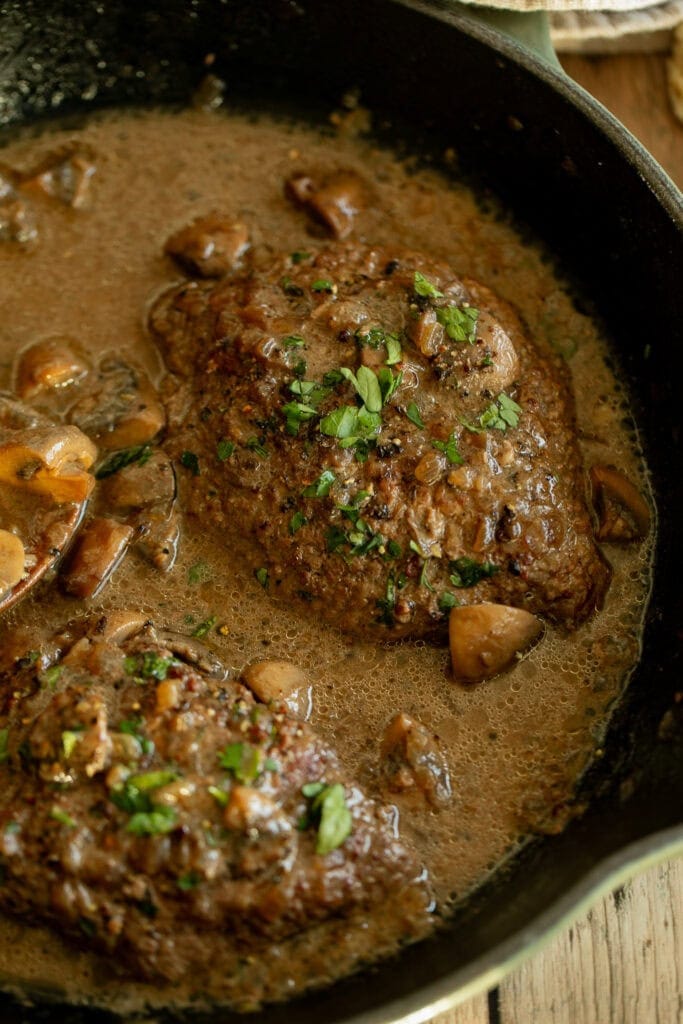 cast iron with cube steaks, pan sauce, and mushrooms