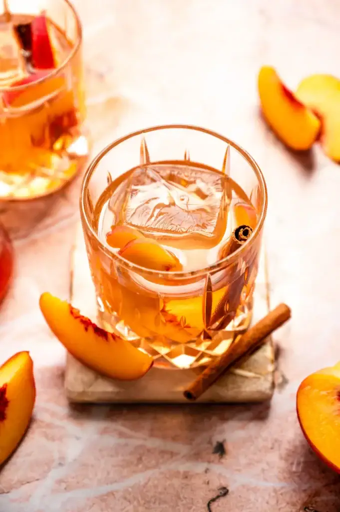 Cocktail glass with old fashioned and cinnamon sticks