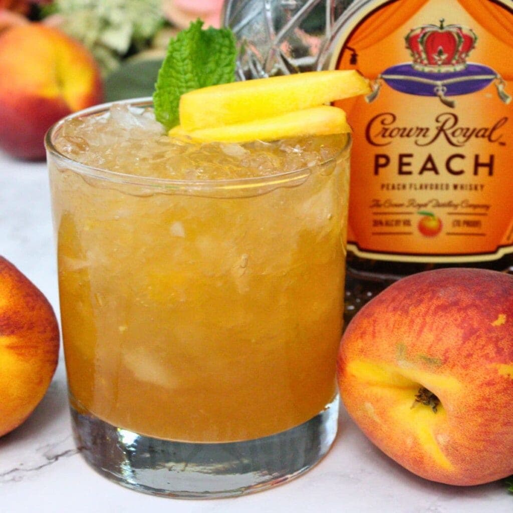 Cocktail glass with a peach whiskey smash