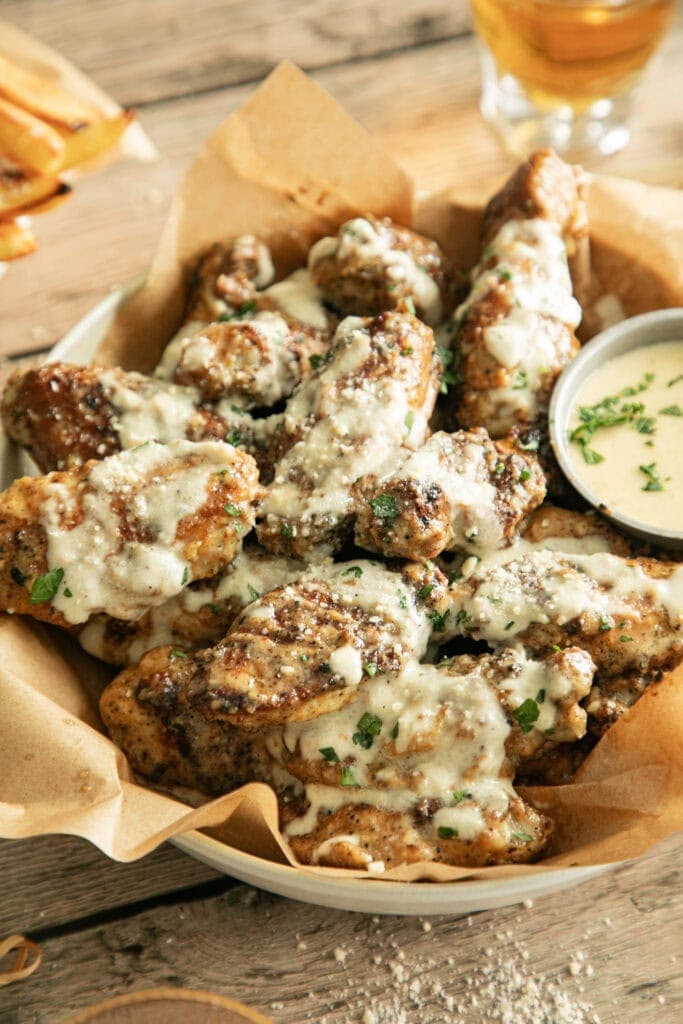 bowl of pan-fried chicken wings with sauce