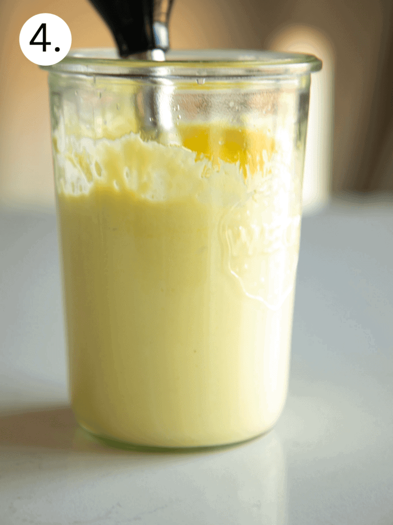 large glass jar with homemade mayo and an immersion blender